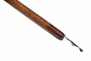 black ink drop on tip of nib of brown dip pen
