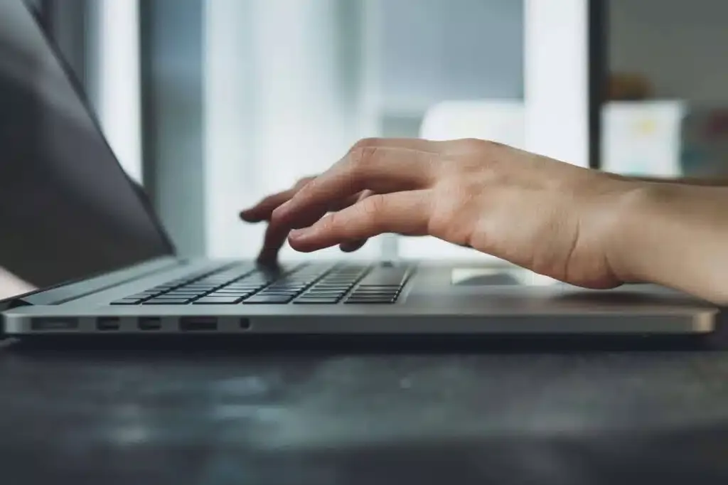 woman's hands working on laptop computer